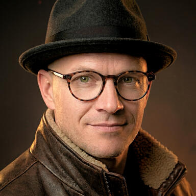 Headshot of PRAYPREY creator, Adam J. Spencer.